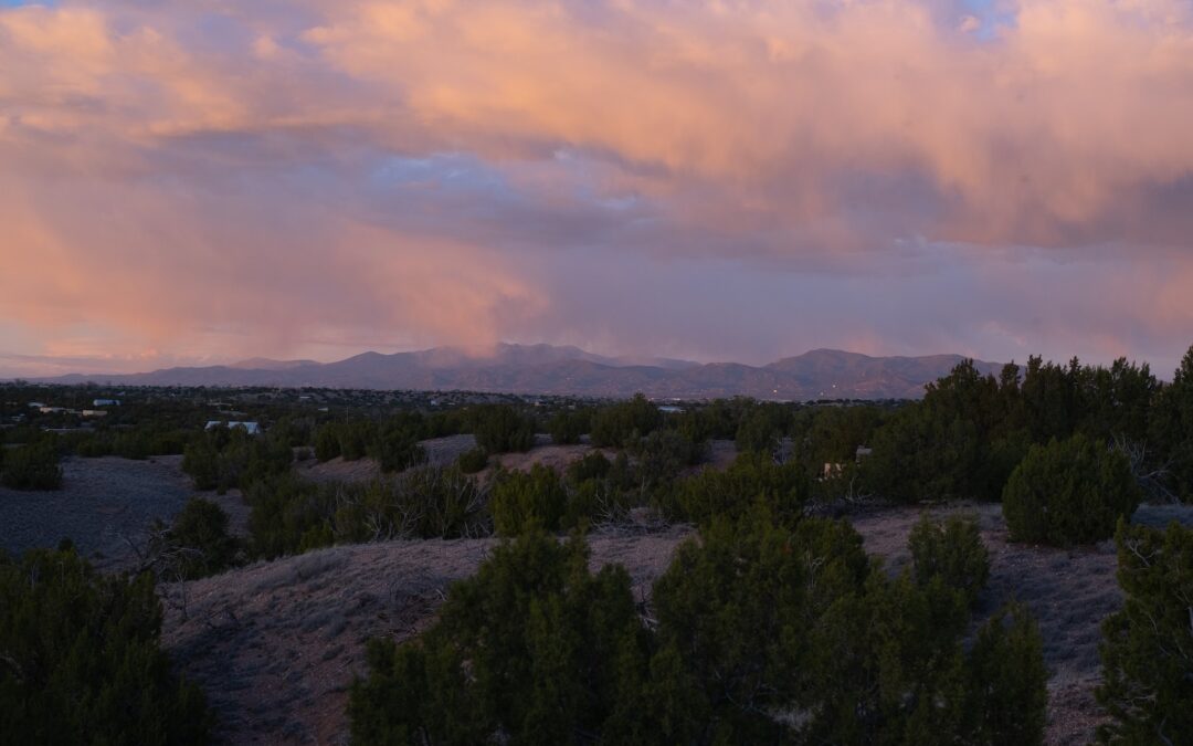 Aerial view of Santa Fe at dusk with pink clouds as the sun sets